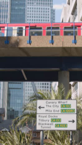 Vertical-Video-Of-Modern-Offices-And-DLR-Train-In-London-Docklands-UK-1